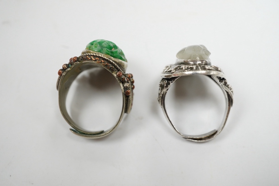 Two Chinese or Burmese jadeite or jade mounted white metal rings. Condition - fair